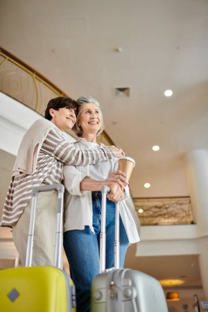 Photo for A loving senior lesbian couple standing gracefully by each other. - Royalty Free Image