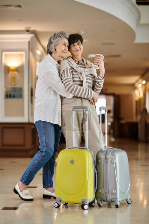 Senior lesbian couple ready for adventure with luggage in hand.