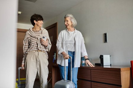 Photo for Senior lesbian couple with a suitcase. - Royalty Free Image