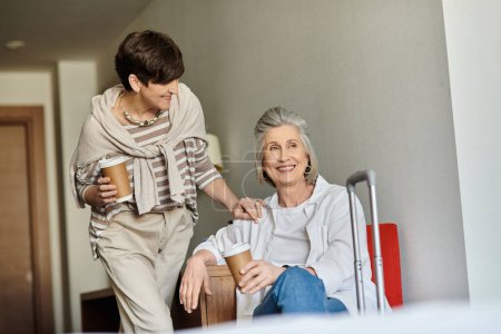 Photo for Senior lesbian couple enjoys a coffee. - Royalty Free Image