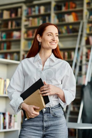 A redheaded woman in jeans and a white shirt tutors in a library, after-school lessons.