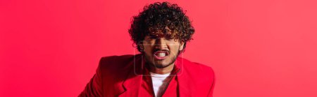 Photo for A handsome young Indian man in vibrant outfit making a funny face with his mouth open. - Royalty Free Image