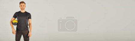Photo for A man in active wear stands confidently in front of a white background. - Royalty Free Image