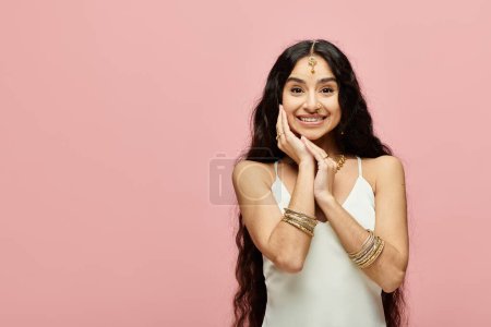 Photo for Stunning indian woman with hands gracefully positioned on her face in a poised pose. - Royalty Free Image