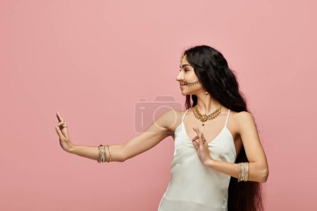 Photo for Young indian woman in a white dress posing actively. - Royalty Free Image