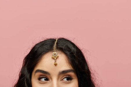 Téléchargez les photos : Femme indienne élégante présentant une magnifique tiare en or. - en image libre de droit