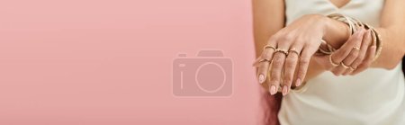 Photo for Young indian woman in white dress, adorned with gold rings, striking a graceful pose. - Royalty Free Image