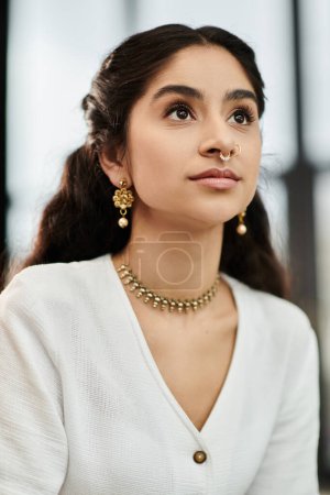 A young indian woman proudly showcases her necklace and earrings.