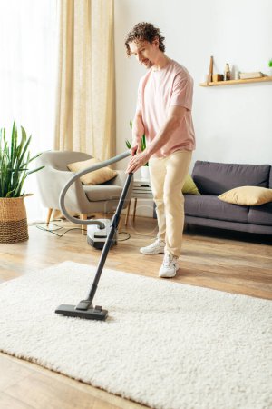 Man in action using vacuum to clean rug.