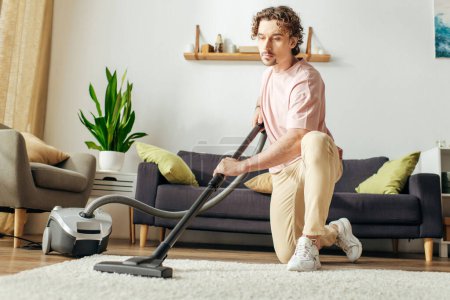 A man in cozy homewear vacuums the living room.