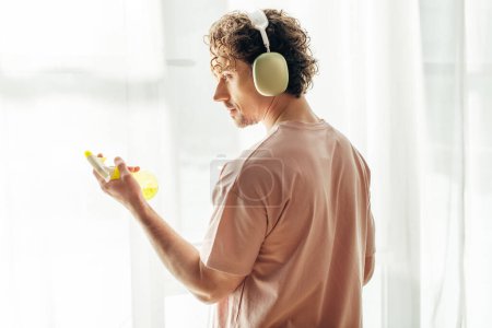 A man in headphones with spray.