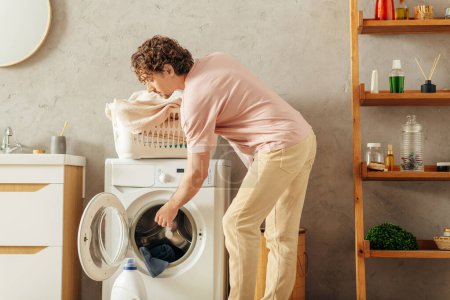 A man in cozy homewear doing something inside a washing machine.