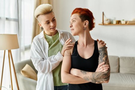 Two women with short hair engaging in a conversation in a cozy living room setting.