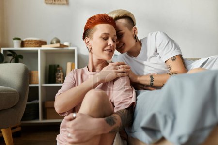 Photo for An intimate moment captured as two women with short hair embrace in a warm hug on a cozy bed in a bedroom. - Royalty Free Image