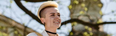 Photo for A woman with a shaved head radiates joy as she smiles warmly. - Royalty Free Image
