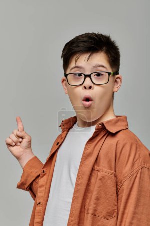 A charming boy with Down syndrome playfully gestures in glasses.