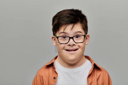 Photo for A charming little boy with Down syndrome playfully making a funny face. - Royalty Free Image
