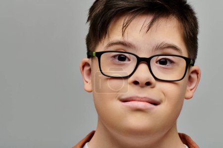 A little boy with Down syndrome posing for a portrait.