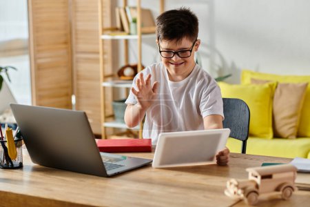 A adorable boy with Down syndrome engrossed in using a laptop at home.