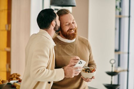 Two bearded men, a happy gay couple, are enjoying breakfast together in a modern kitchen.