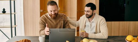 Photo for Two men sit at a table, engrossed in their laptop, collaborating and sharing ideas in a modern apartment setting. - Royalty Free Image