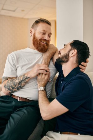 Two men in casual attire, embracing each other warmly on a cozy couch in a modern living room.