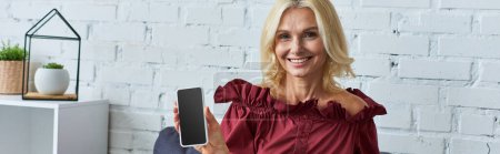 Photo for Stylish woman in red top, empowered with phone. - Royalty Free Image