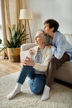 Photo for Two elderly women enjoying a cozy moment on a living room couch. - Royalty Free Image