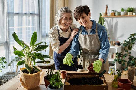 Two women in aprons plant a sprout in a pot in a cozy setting.