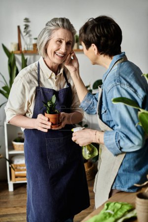 Photo for Two women engaged in conversation while in a kitchen. - Royalty Free Image