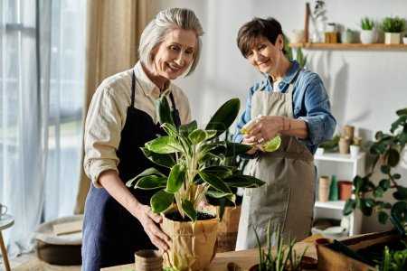 Two women in aprons tending to a potted plant.