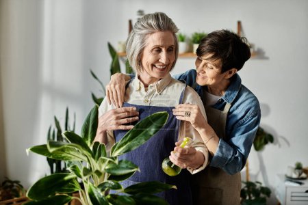 Two women in aprons caring for a potted plant.