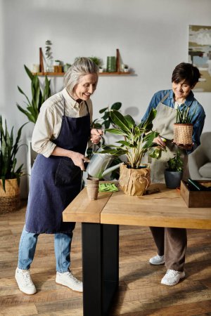Two women in aprons watering plants in a cozy living room.