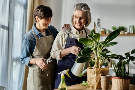 Mature lesbian couple in aprons nurturing a plant together.