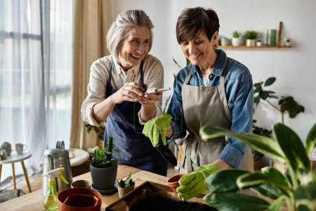 Two women in aprons caring for a plant together.