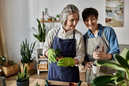 Two women in aprons admiring plants together.