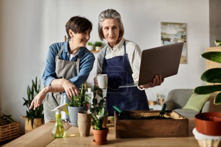 Photo for Loving lesbian couple captivated by laptop screen in cozy kitchen. - Royalty Free Image
