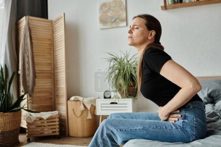 A woman sitting on a bed, visibly in discomfort due to depression.