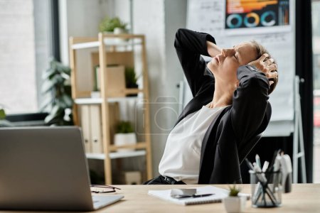 Middle aged woman experiences stress and depression while working at her desk.