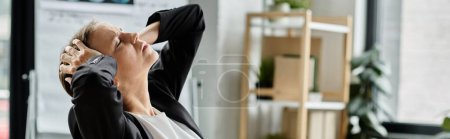 Middle aged woman in business suit stretching in office.