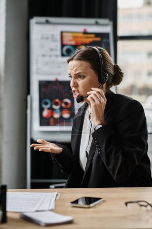 Woman in business suit having a stressed phone conversation.