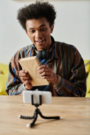 African American blogger balancing phone and tablet while vlogging.