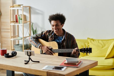 Téléchargez les photos : A young man strums his acoustic guitar in a cozy living room. - en image libre de droit