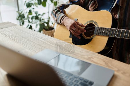 Téléchargez les photos : A guitarist strums passionately in front of a phone while connecting digitally. - en image libre de droit