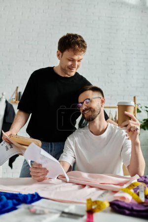 Two men in love, creatively collaborating over a piece of paper at a stylish table.
