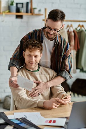 Photo for Two men in designer atelier, working together on laptop - Royalty Free Image