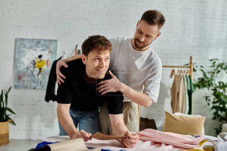 gay men crafting clothing designs at a table in a stylish workshop.