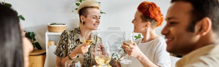 Photo for Diverse group enjoys wine around table. - Royalty Free Image