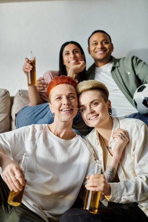 Photo for Diverse group gathers on top of a couch. - Royalty Free Image