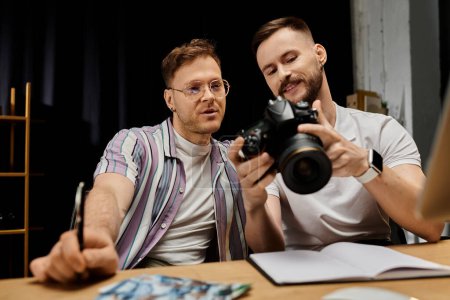 Zwei liebevolle Männer betrachten Fotos ihrer modernen Kamera.